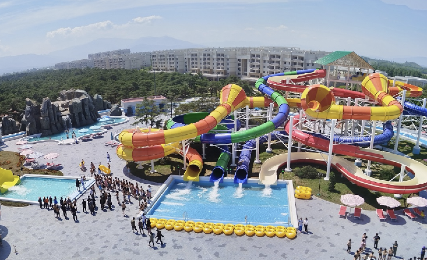 Spiral and bowl-style water slides at Myongsasimni Water Park in Wonsan