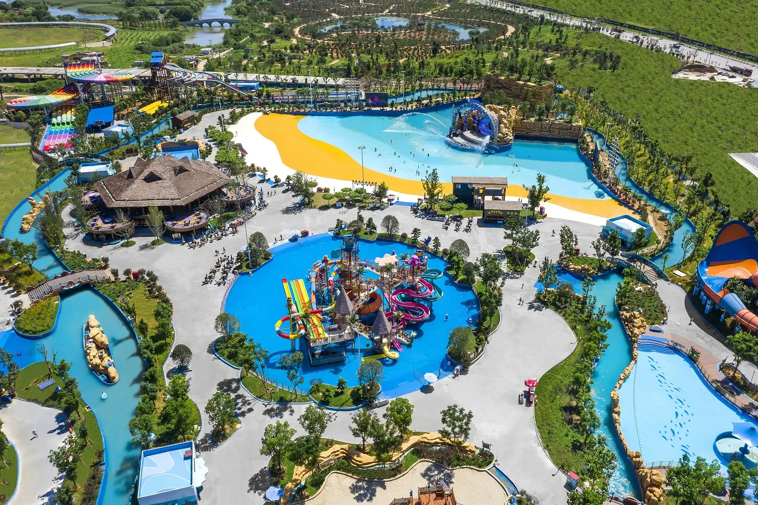 Aerial view of Taihu Dragon Dream Water Park with a wave pool, slides, and family water-play areas